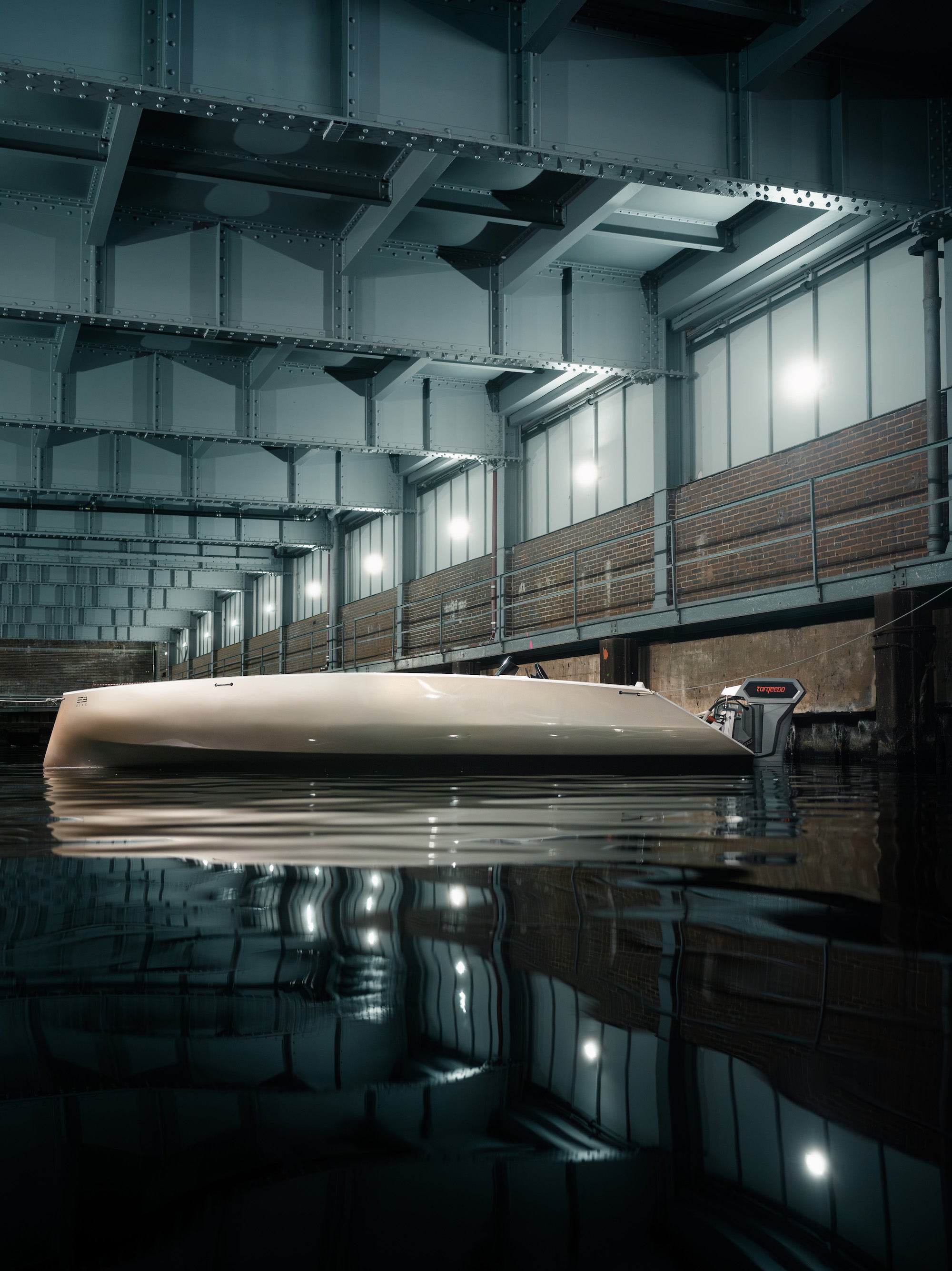 Boat inside a dark, lightly lit boat hangar