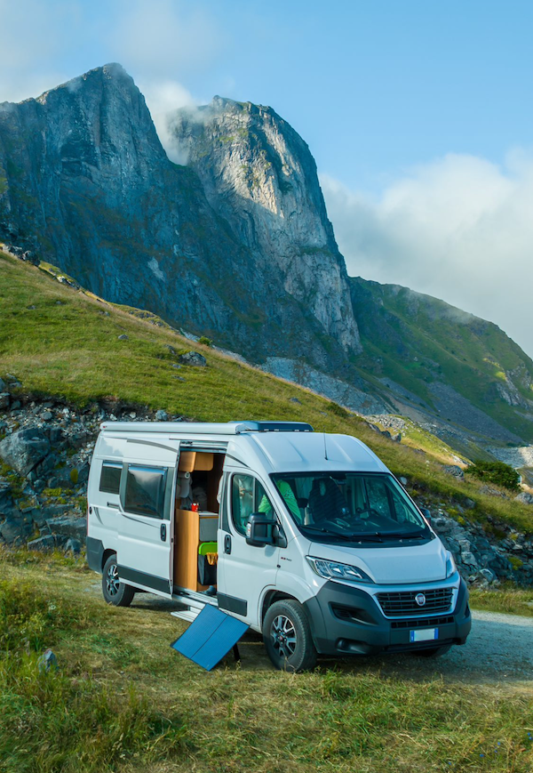 A campervan in front of a mountain